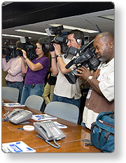 Cameramen filming in a conference room