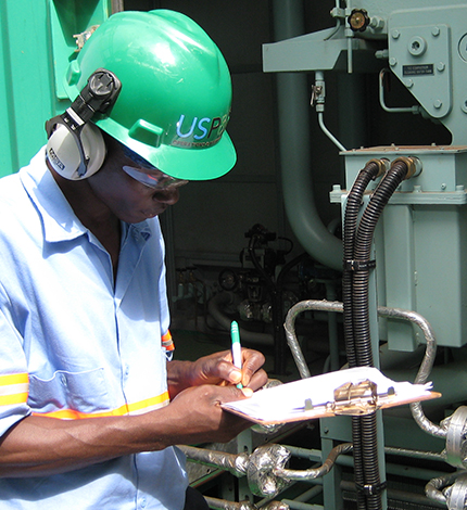 maintenance worker performing maintenance or an assessment on generator