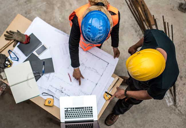 Engineers reviewing a blueprint.