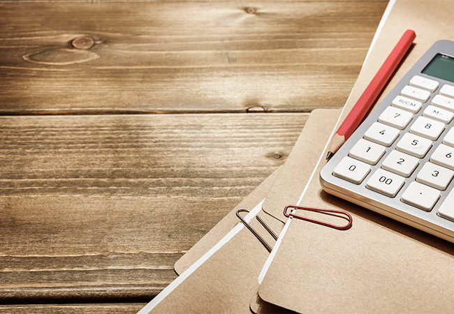 File folders with a pencil and calculator.