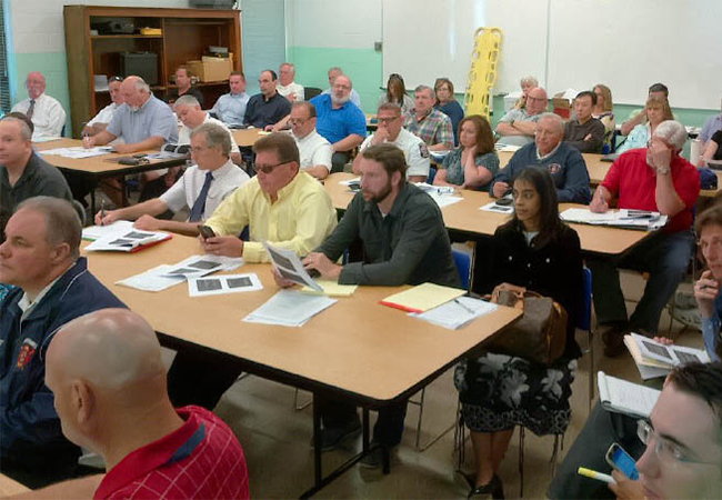 Officials and representatives of private non-profits attend an Applicants Briefing.