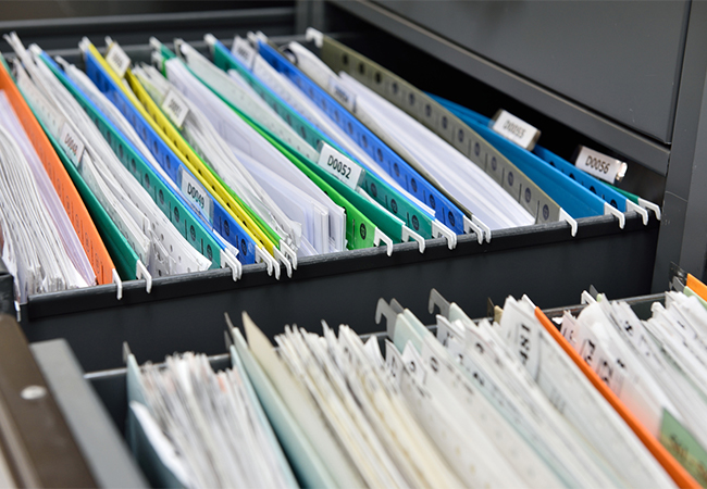 File drawers filled with file folders and paperwork.