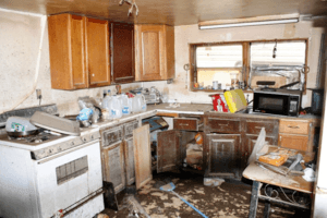 Kitchen with water damage and debris from flooding