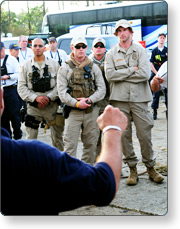 A group of emergency responders receiving an operational briefing.