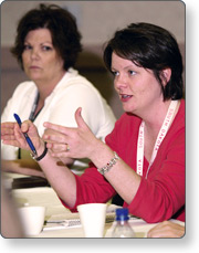 A woman sitting at a table talking