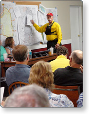 A group of people in a classroom watching the instructor
