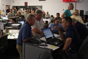 Baton Rouge, La., September 3, 2008-FEMA employees in the EOC, group together to discuss events taking place throughout the day.