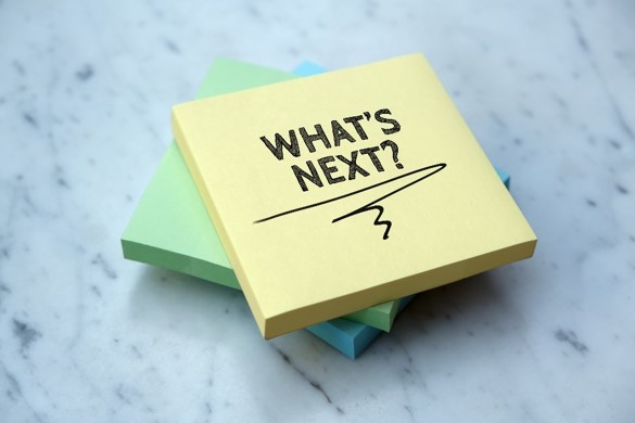 A close up of a sticky note with the words What's Next