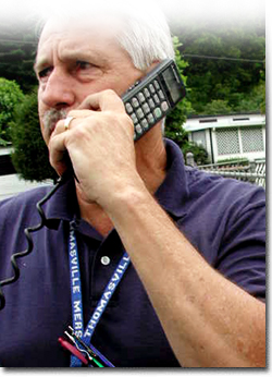 Emergency management official communicating by satellite phone