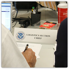 Table sign that reads Logistics Section Chief