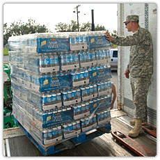 A Soldier helps with the distribution of ice and water at a distribution site