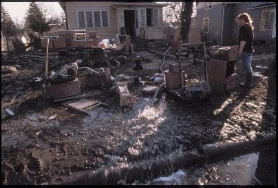 Grand Forks, ND, April 15, 1997 - Residents of Grand Forks muck out their homes and use pumps to remove water from basements.  The Red River flood...