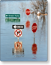 Road signs sticking out above deep floodwaters.