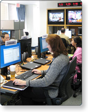 Graphic showing several individuals at desks working at their computer, illustrating Coordination at the Emergency Operations Center