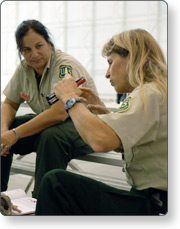 Two responders sitting on bleachers