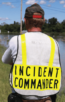 Photo of a responder wearing Incident Commander vest, viewed from back.