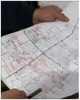 Hands holding a Liberty County map with handwritten notes.
