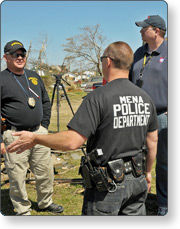 Police officers (Mena Police Department) planning talking at an incident scene.