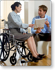 Two people meeting, both seated, one in a wheelchair