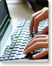 Hands typing on a computer keyboard