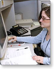 Person at a desk using a template to create a warning message