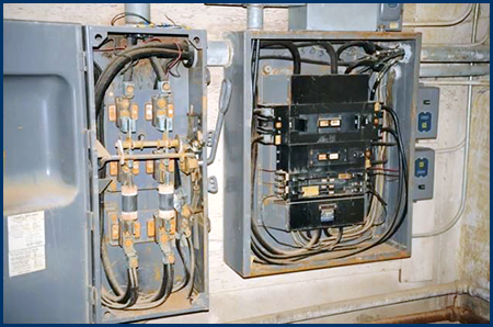 Photo of two open electrical circuit boxes