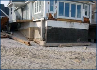 Photo of a large house with evidence of shifted foundation due to major cracks