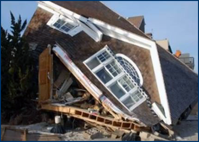 Photo of a structure in near collapse from extensive frame damage