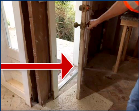 Photo of a person partially opening a door with a big red arrow pointing to it