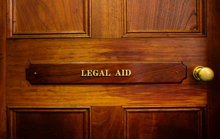 Legal Aid sign on door in a courthouse