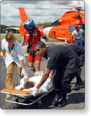 U.S. Coast Guard personnel evacuating a disaster victim