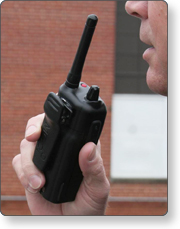 Person communicating by handheld radio