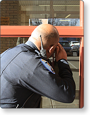 Law enforcement officer looking in a window