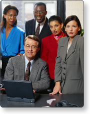 Five planning team members gathered around a laptop