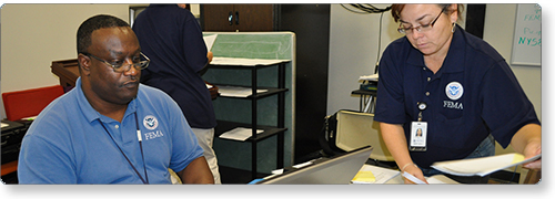 Three FEMA employees at work.