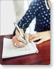 Person writing in a notebook.