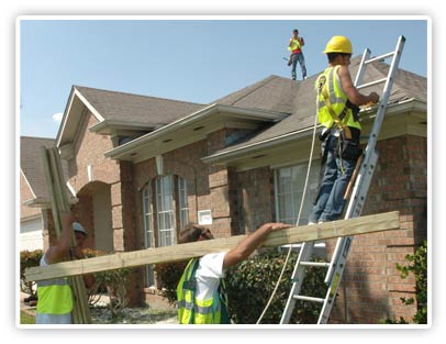 Selectable photo of contractors repairing a house damaged by a hurricane