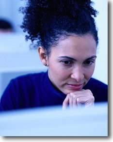 Woman looking thoughtfully at a computer