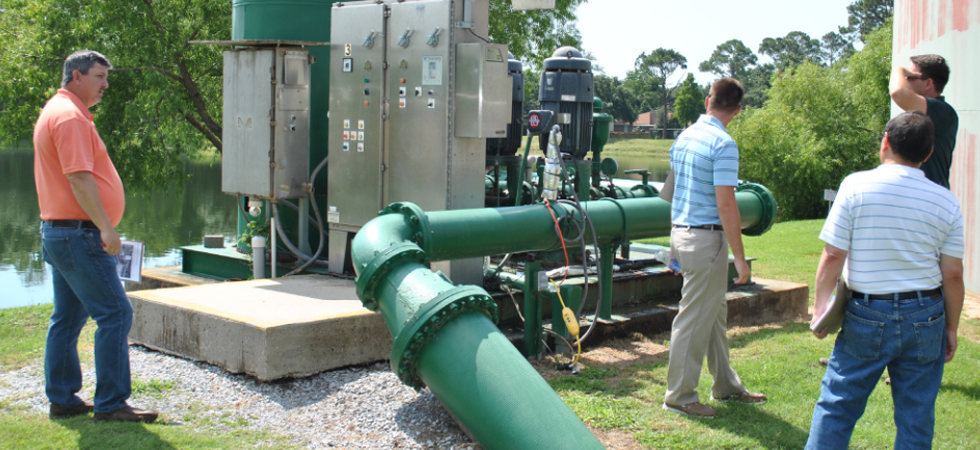 workers check on a generator