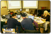 People in a meeting room all communicating with one another
