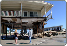 Damaged home elevated on stilts.