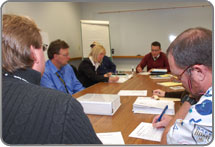 Stakeholders conducting damage assessment planning meeting.