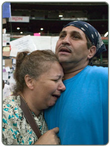 Man and woman react to the reality of the disaster.