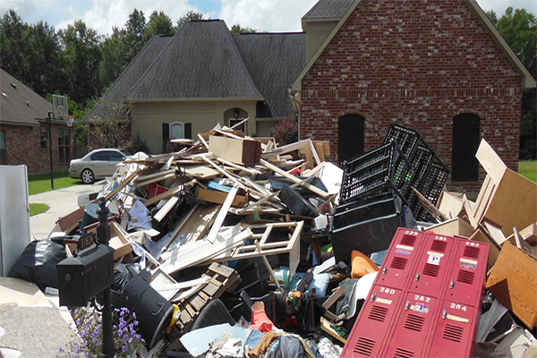 Debris from hurricane piled in front of homes by the curbside.