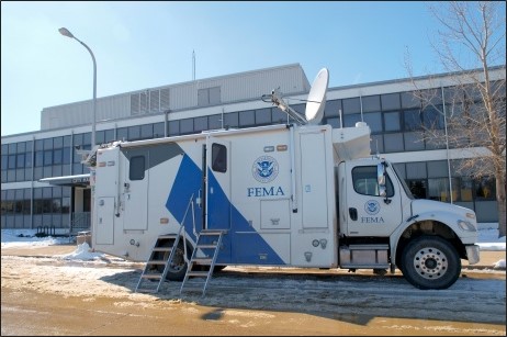 FEMA truck in front of building.