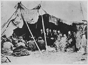 Photo of General William T. Sherman signing peace treaty with Sioux Chiefs in Wyoming, 1868