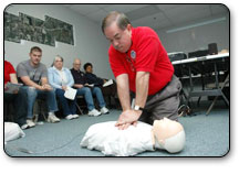 A man demonstrates how to perform CPR on a mannequin