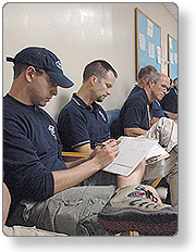 Personnel documenting their qualifications on forms