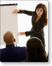 A woman pointing to an easel chart