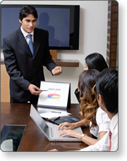 a man pointing to a presentation in the front of participants
